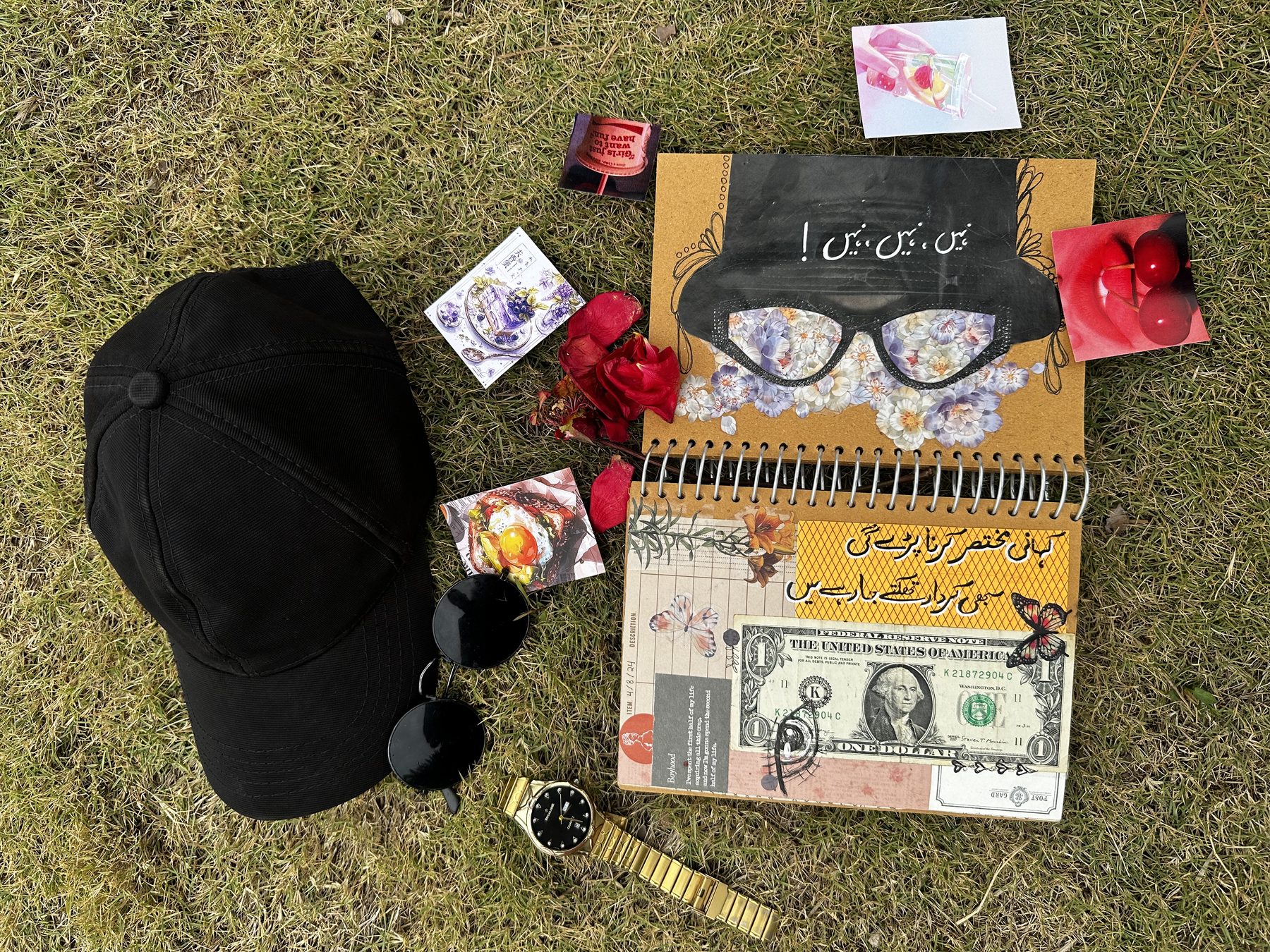 Sketchbook flat lay with cap and sunglasses