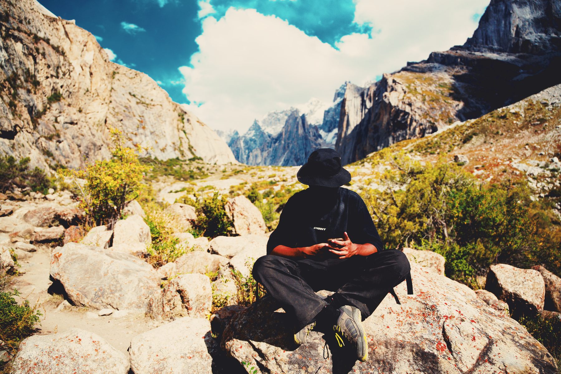 Resting on boulders below granite peaks